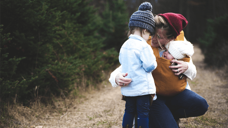 Children hugging mother