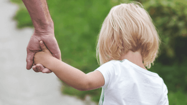 Daughter holding mother's hand