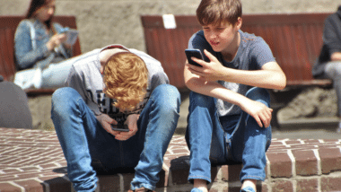 Boys looking at smartphones