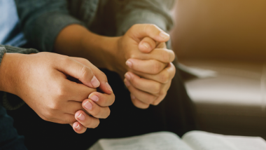 Hands clasped in prayer