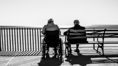 Elderly couple looking out to sea