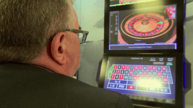 Man using gambling machine