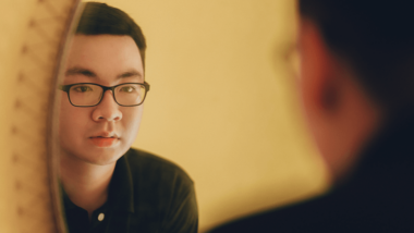 Person looking into mirror